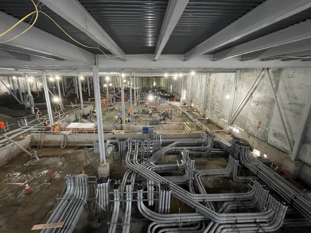 Elite Electrical Contracting commercial interior with grouped electrical conduit pathways before finish work