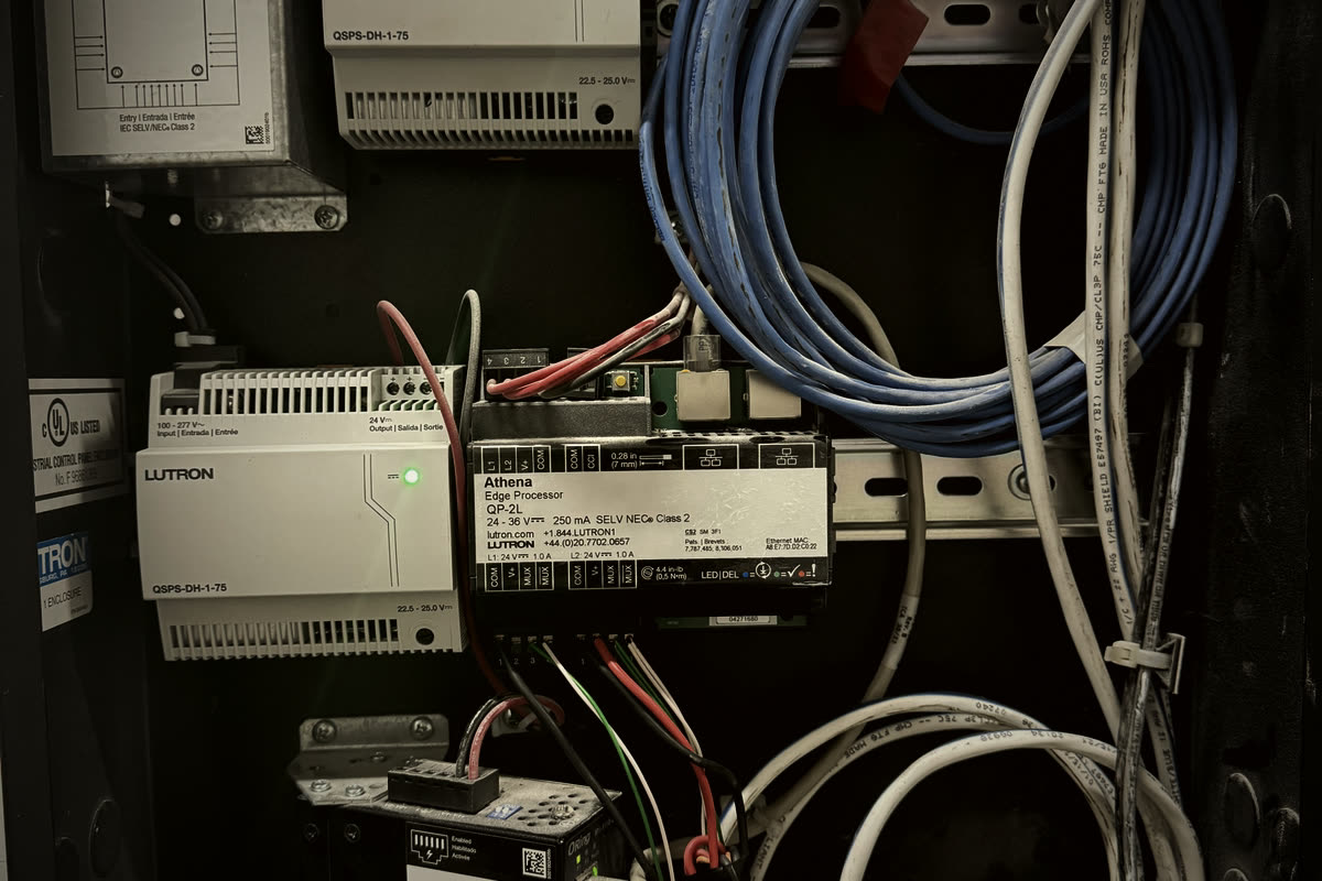Lutron HomeWorks Athena Edge Processor QP-2L and QSPS-DH-1-75 power supply installed in a Restrepo Innovations head-end panel