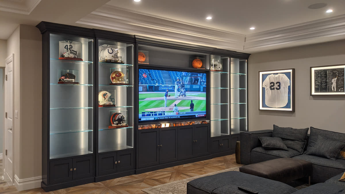 Stellmann Electrical family room media wall with integrated display and built-in cabinetry