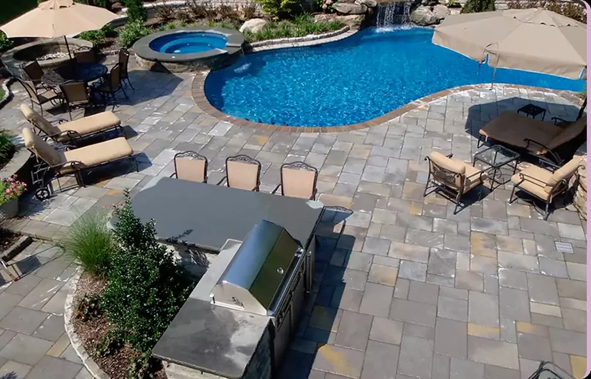 Terracare Landscaping custom outdoor living space with a covered seating area, stonework, and mature planting in Northern New Jersey