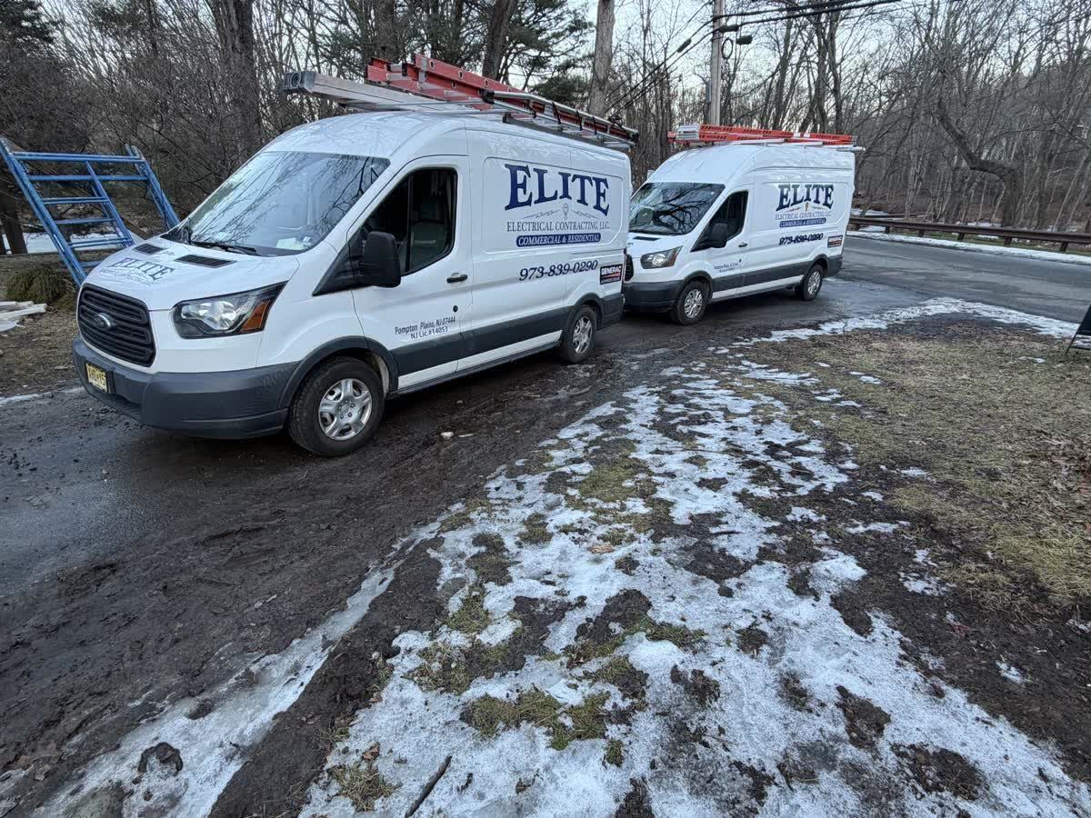 Elite Electrical Contracting service vans with Generac authorized dealer decal parked on a Pequannock NJ job site