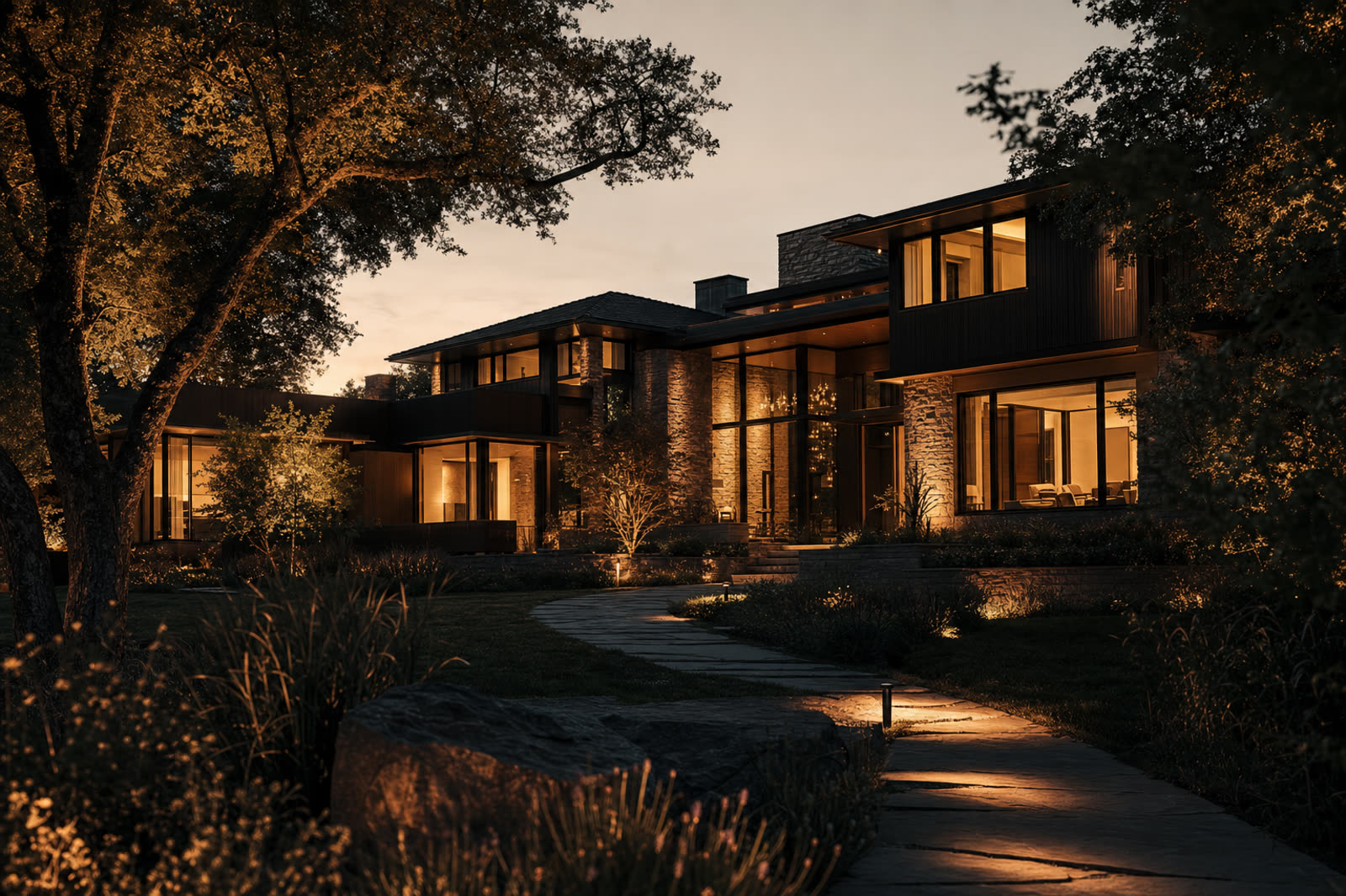 Twilight exterior of a forever home with warm interior glow in the trees